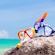 Snorkeling goggles on top of a rock overlooking the Caribbean Sea